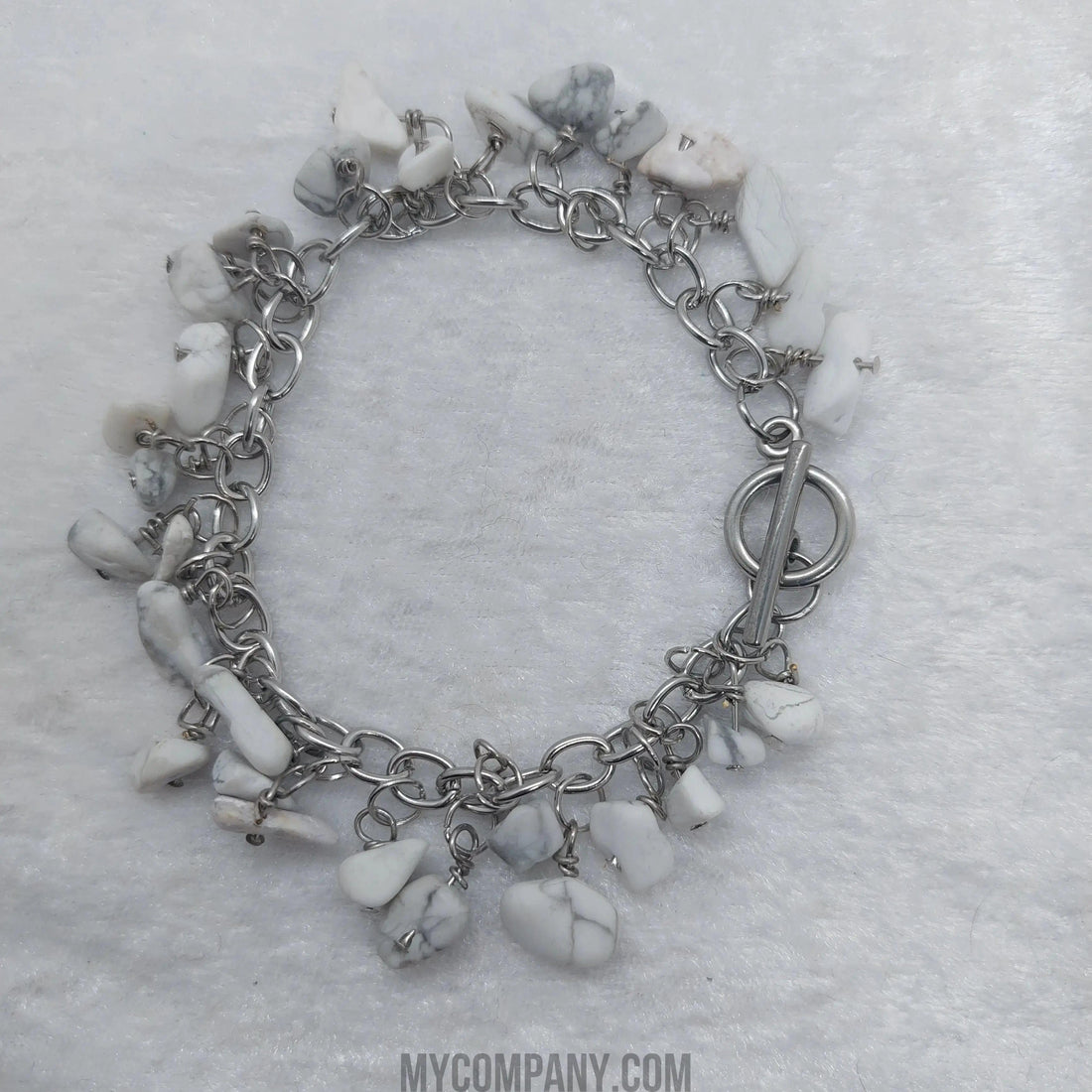 Silver stainless steel charm bracelet with white howlite gemstone chips and a toggle clasp.