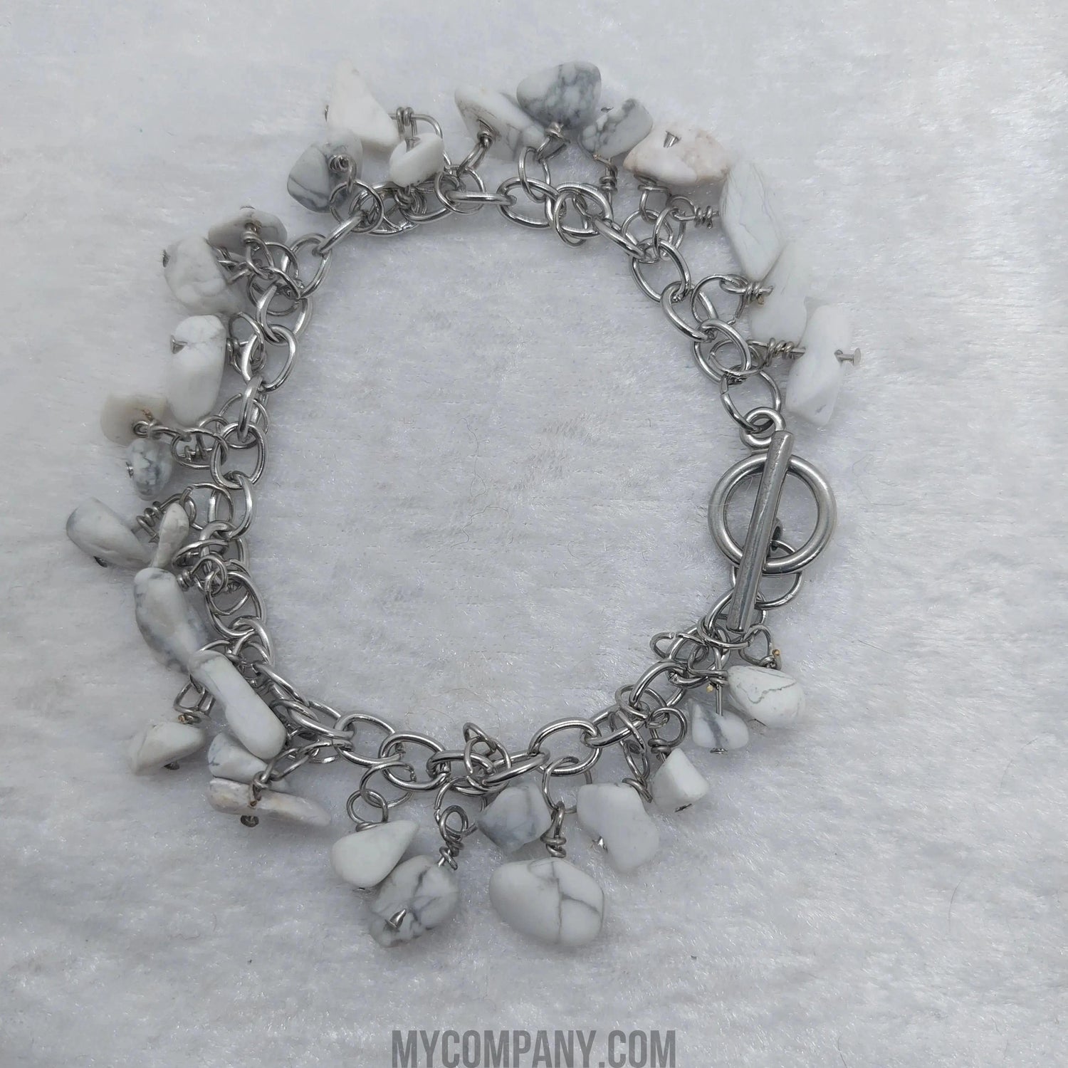 Silver stainless steel charm bracelet with white howlite gemstone chips and a toggle clasp.