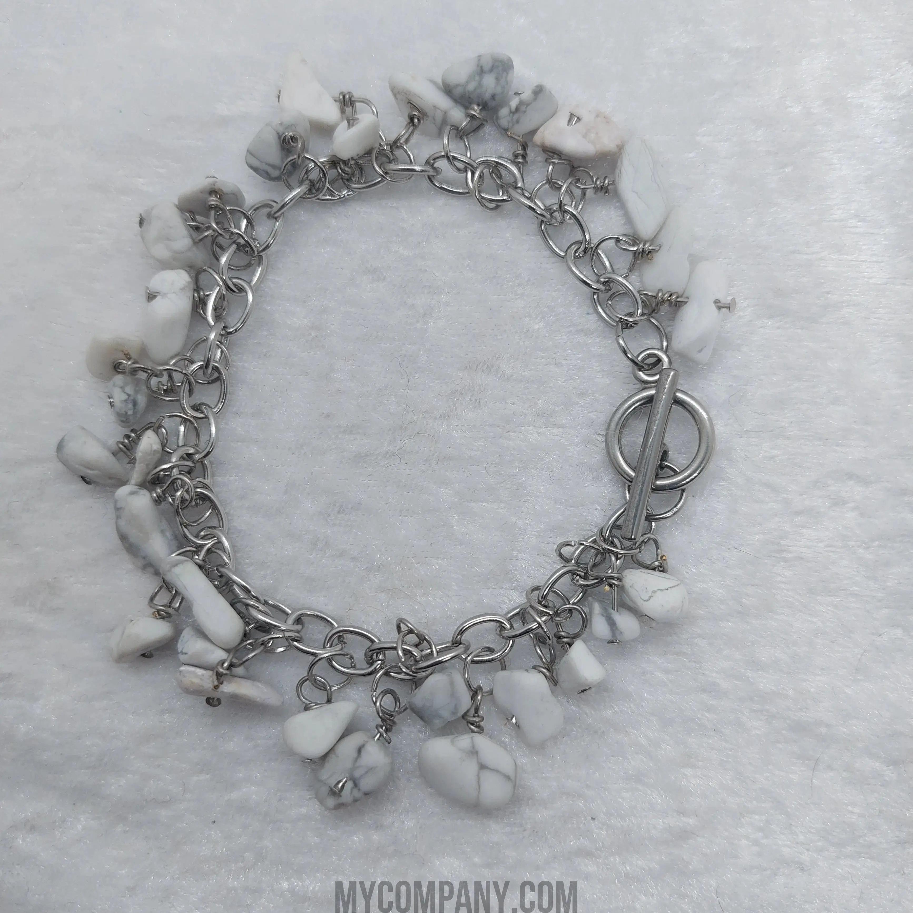 Silver stainless steel charm bracelet with white howlite gemstone chips and a toggle clasp.