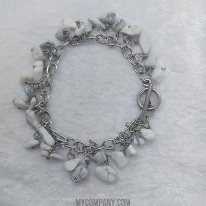 Silver stainless steel charm bracelet with white howlite gemstone chips and a toggle clasp.