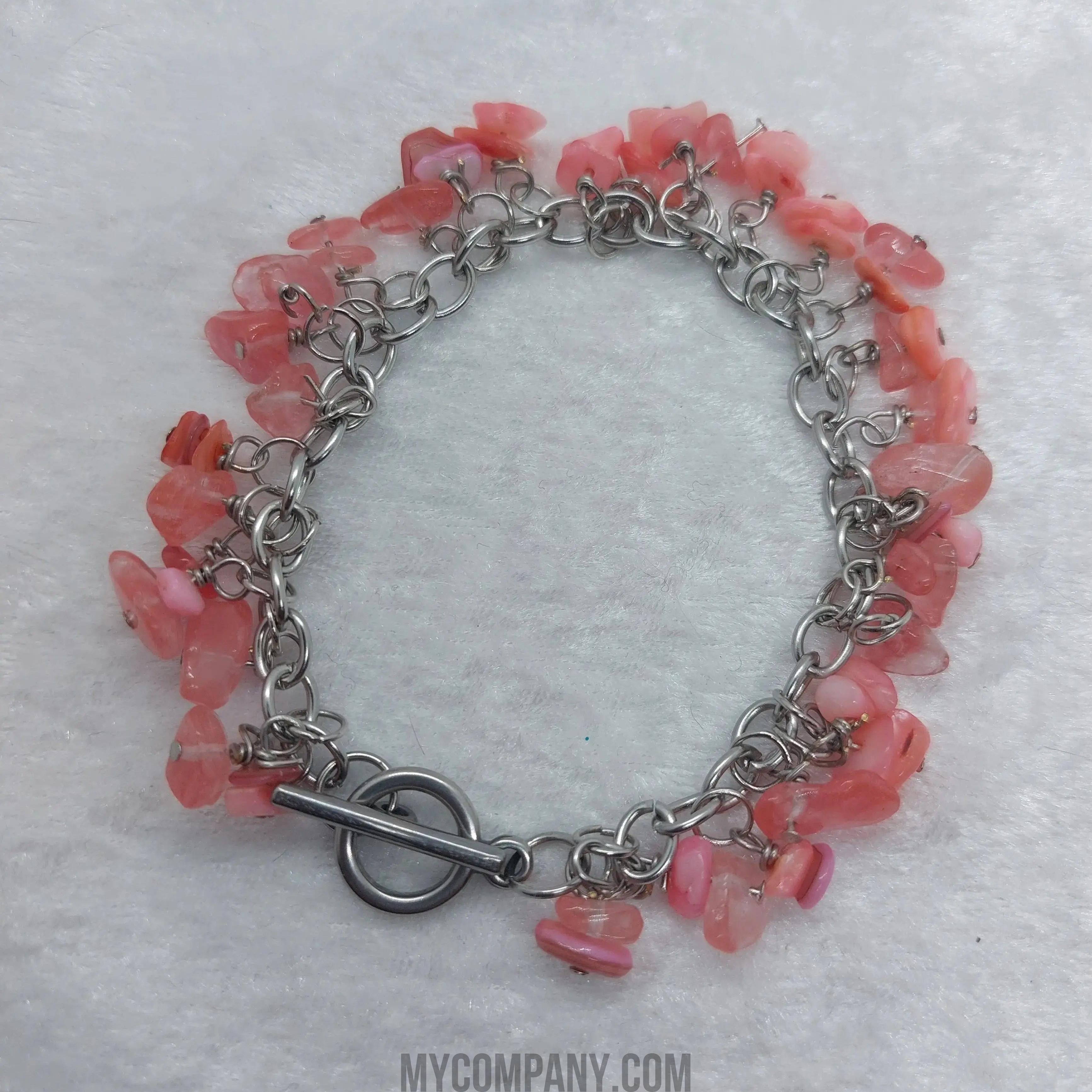 8-inch stainless steel bracelet with pink coral chip gemstone dangle charms and a toggle clasp.