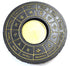Circular metal tealight candle holder with 12 zodiac signs in gold relief on black finish for astrological altar décor
