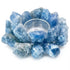 A 4.5-inch carved blue calcite tealight candle holder showing pale sky-blue coloring with natural white veining and a circular hollowed center for the tealight