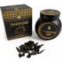 Black jar of Sonavi Amber Oud bakhoor incense chips with decorative gold lid, next to its matching box, with small oud wood pieces scattered on the surface — 40g warm amber and oud resin blend for ritual and meditation.