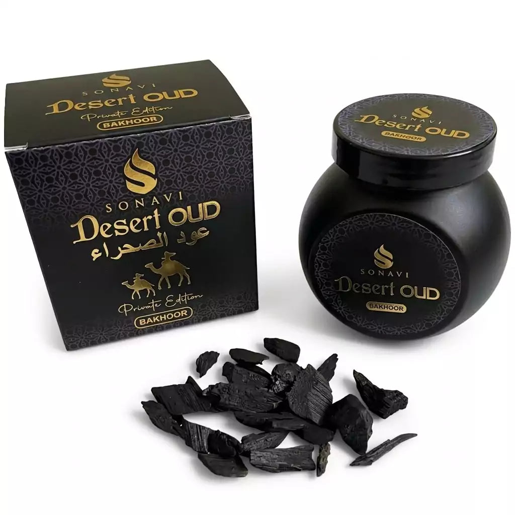 Jar of Sonavi Desert Oud bakhoor incense chips next to its decorative box, with small oud wood pieces scattered around — 40g natural agarwood blend inspired by desert nights.