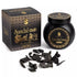 Black jar of Sonavi Sandal Oud bakhoor incense chips with gold label, next to its decorative box with intricate designs, and small oud wood pieces scattered in front — 40g natural sandalwood and agarwood grounding blend.
