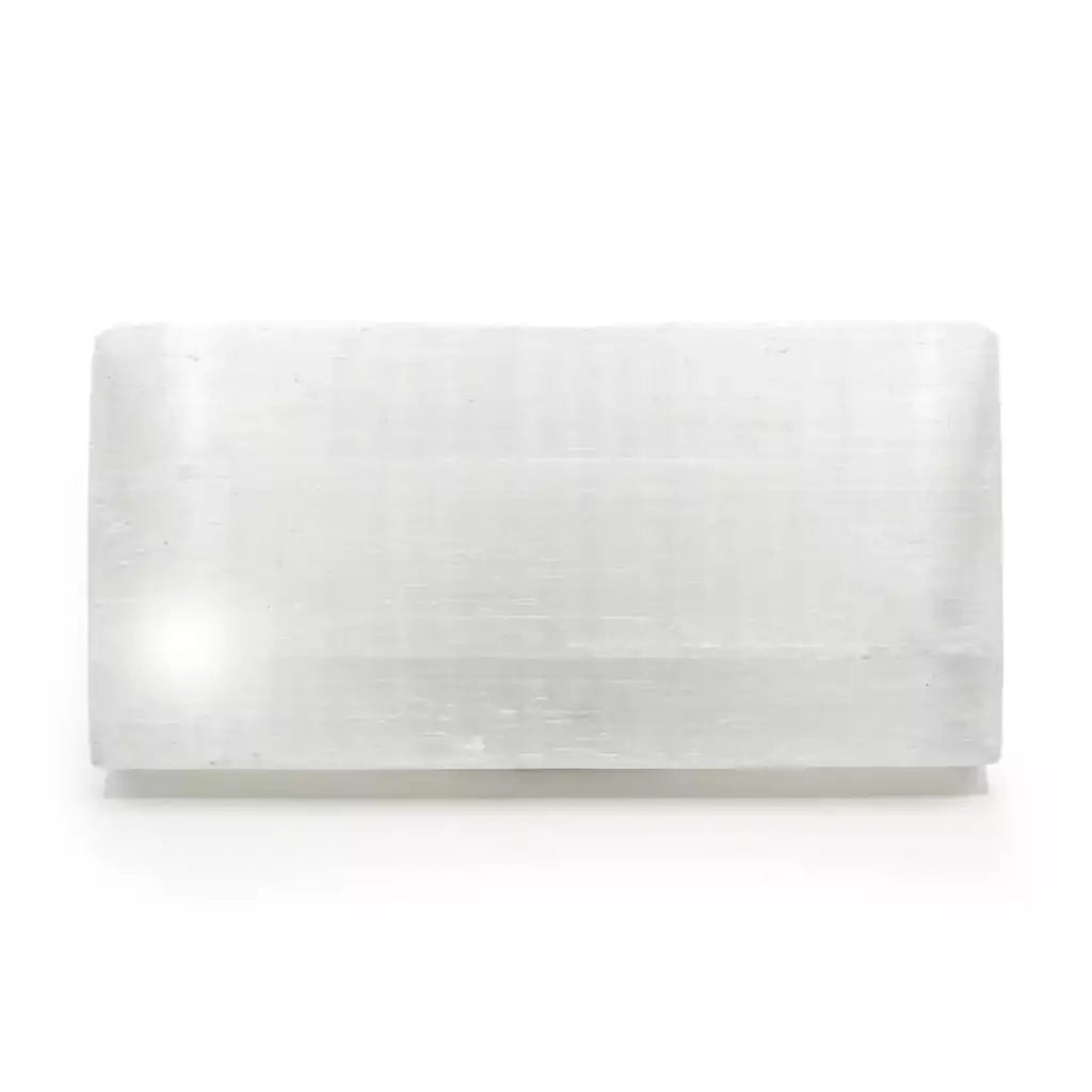Flat polished white selenite charging plaque measuring 4 by 8 inches, showing smooth satin spar surface with fine fibrous streaks on a neutral background