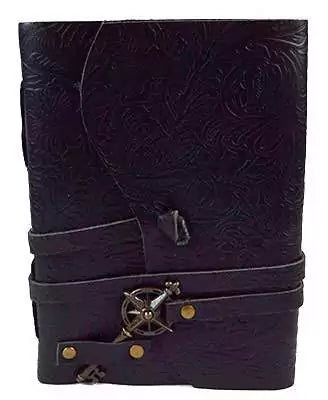 5x7 black genuine leather journal with embossed floral pattern, secured with a decorative cord and compass-style key closure, shown closed on a neutral background.