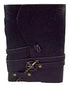 5x7 black genuine leather journal with embossed floral pattern, secured with a decorative cord and compass-style key closure, shown closed on a neutral background.