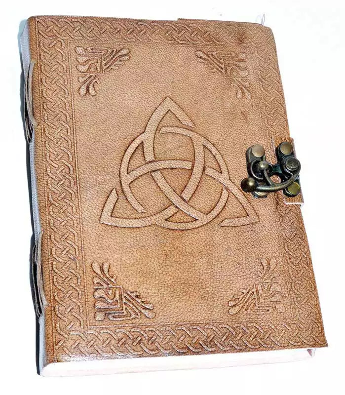 5x7 inch leather-bound journal with embossed triquetra Celtic knot design on the cover and metal latch closure, filled with handmade paper for grimoire and ritual writing.