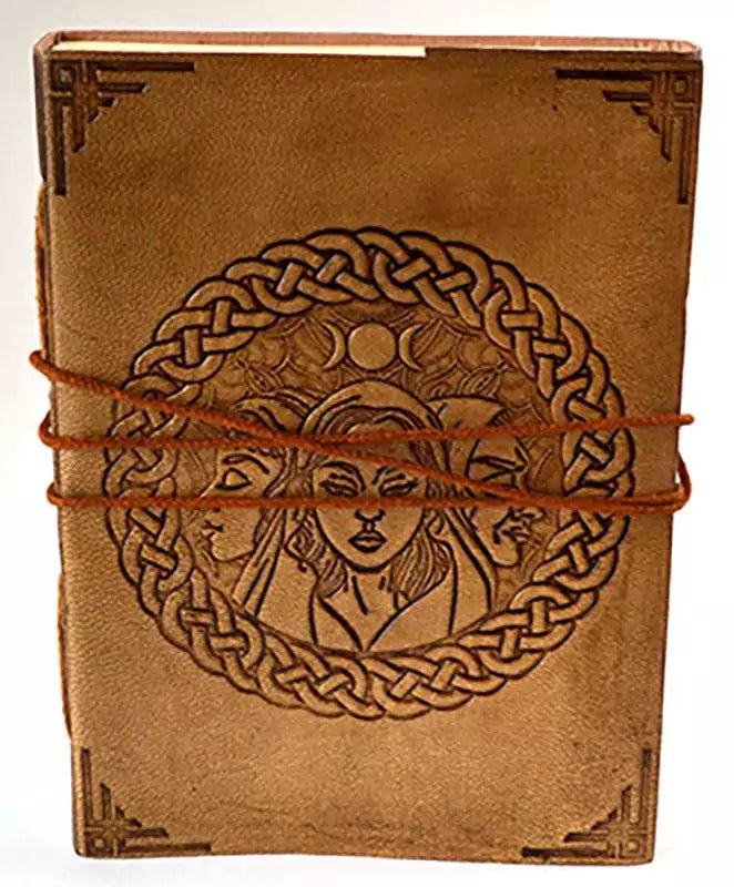 Handcrafted leather journal with triple goddess symbol surrounded by Celtic knot embossing on the cover, tied with a leather cord, 5x7 inches unlined.