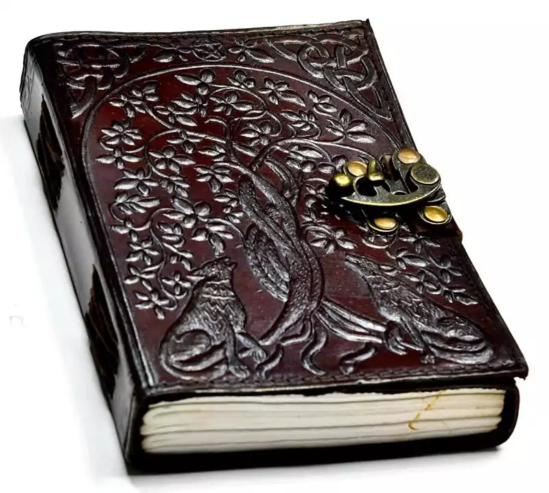 Wolf Tree of Life leather grimoire journal with intricate floral and animal embossed design on cover — 5x7 inch leather journal with metal latch clasp for grimoire and ritual records.