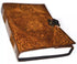 Leather-covered hardcover journal with embossed Celtic designs and a pentagram symbol on the front, secured with a decorative metal latch clasp.