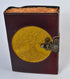 Leather-bound journal with golden embossed Tree of Life design on cover with aged paper and metal latch closure