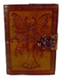 Aged leather-look fairy journal featuring a fairy with spotted wings embossed on the cover, secured with a metal latch, with vintage-style paper inside.