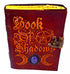 Aged leather-look Book of Shadows journal with metal latch, featuring embossed occult symbolism, for Wiccan grimoire and spell record keeping.