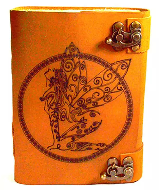 Orange aged leather-look journal with detailed fairy figure embossed within a circular botanical design, secured with decorative metal clasps on the side.
