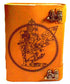 Orange aged leather-look journal with detailed fairy figure embossed within a circular botanical design, secured with decorative metal clasps on the side.