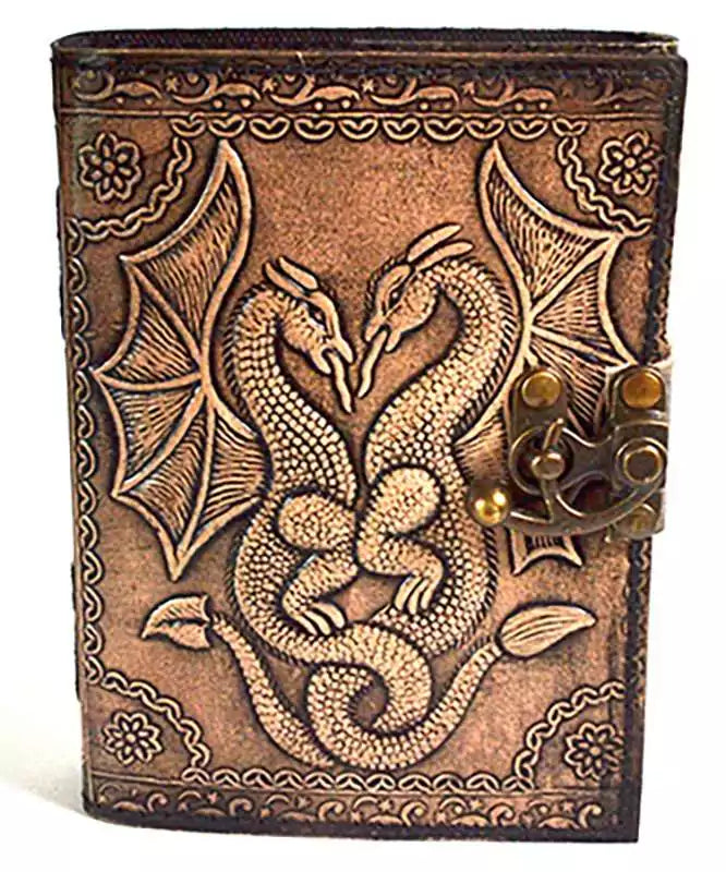 Aged leather-look journal with embossed double dragon design and decorative knotwork on the cover, secured with a metal clasp latch.