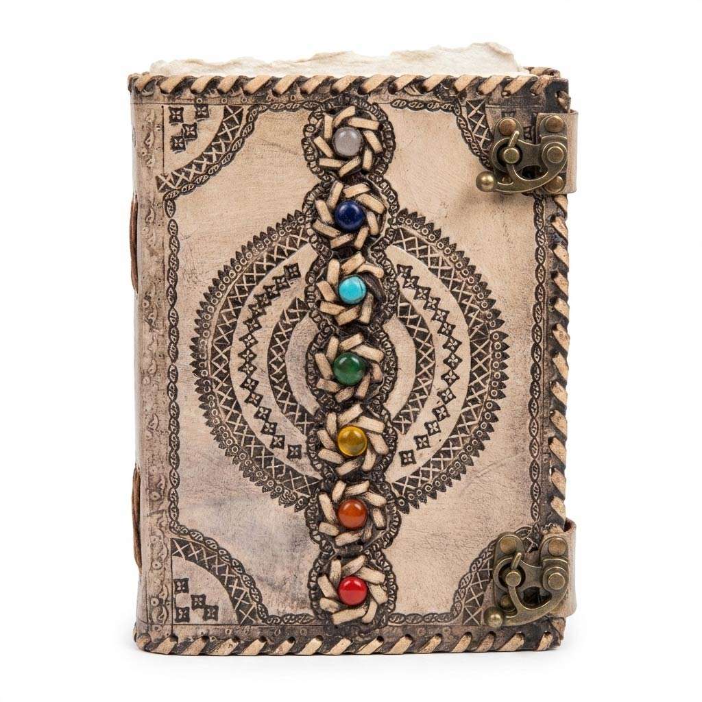 Decorative leather-bound journal with chakra gemstone inlays and intricate tooled patterns on the cover — dual metal clasp closure.