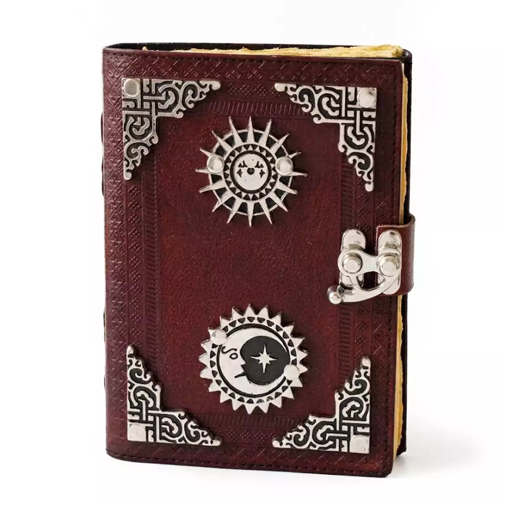 Sun and Moon embossed leather journal with aged paper and latch closure showing celestial grimoire with sun and moon symbols on leather cover