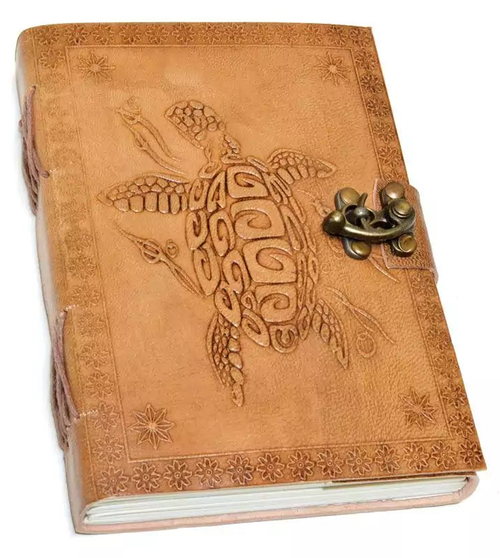 5x7 inch turtle embossed leather journal with cord closure showing detailed raised turtle design on cover and aged parchment-style pages inside — a handmade nature journal.