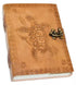 5x7 inch turtle embossed leather journal with cord closure showing detailed raised turtle design on cover and aged parchment-style pages inside — a handmade nature journal.