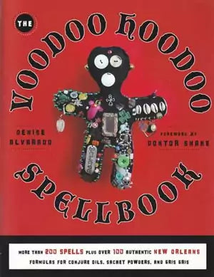 Voodoo Hoodoo Spellbook cover featuring a colorful voodoo doll adorned with charms and buttons against a striking red background.