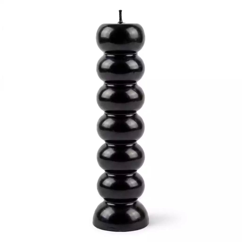 Black seven-knob banishing ritual candle with seven sections for burning one per day to progressively remove obstacles and clear blockages over a week