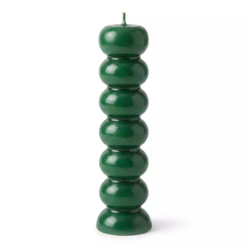 Green seven knob candles for abundance rituals showing seven-segment green wax candle form for weekly intention-setting workings
