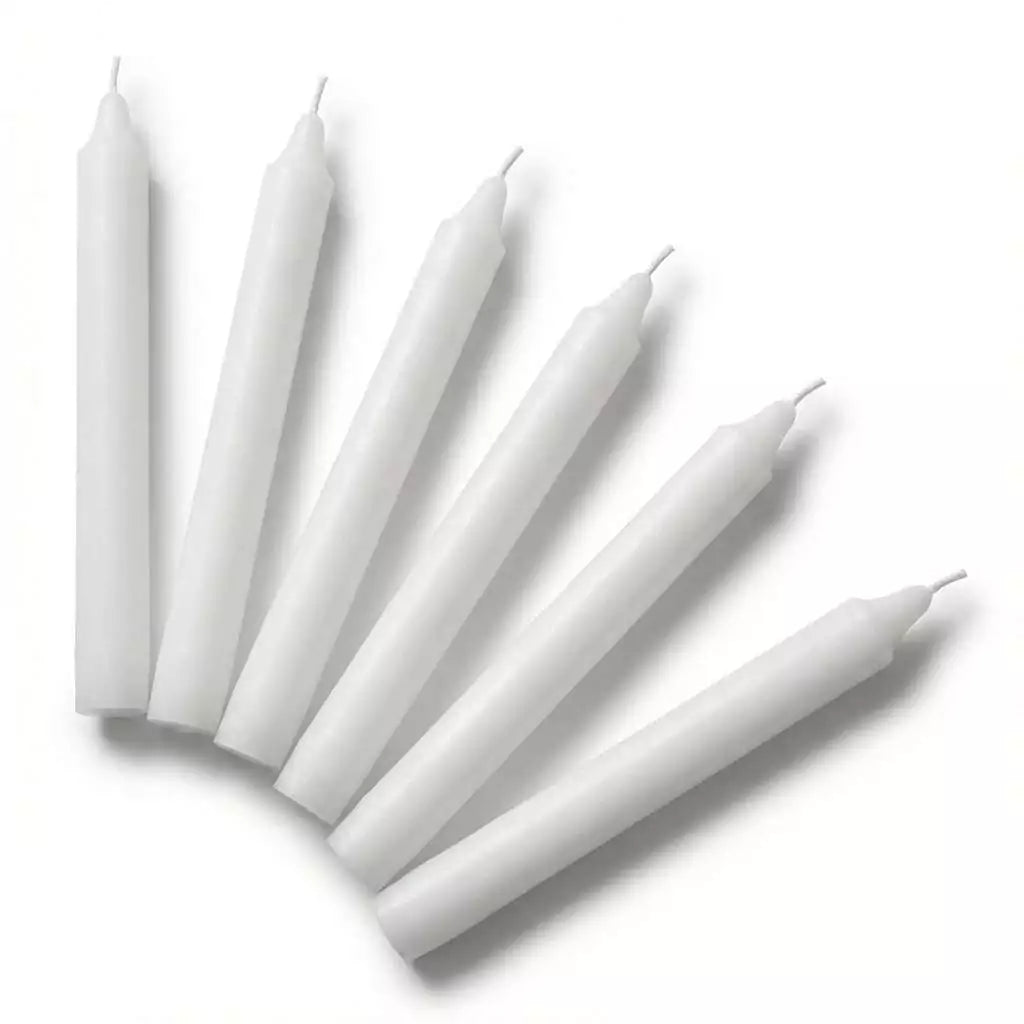Six white tapered household candles arranged in a row with pointed ends, set of 6 versatile white ritual candles for altar and spiritual ceremony use