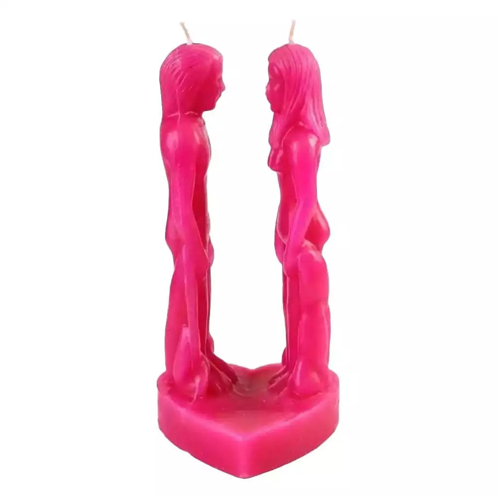 Pink wax candle sculpted as two stylized figures facing each other on a heart-shaped base, for sweet love attraction and new romance hoodoo ritual use.