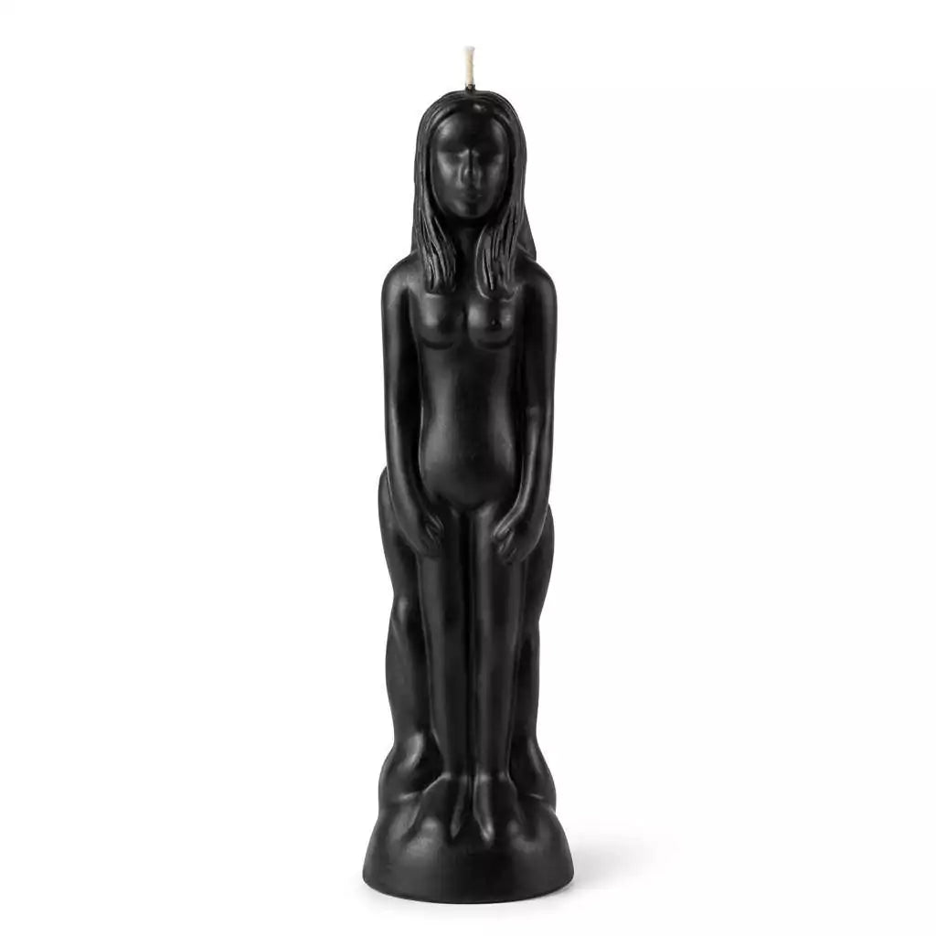 Black wax candle sculpted as a standing female figure with long hair and a wick at the top, for hoodoo protection, banishing, and strength rituals.