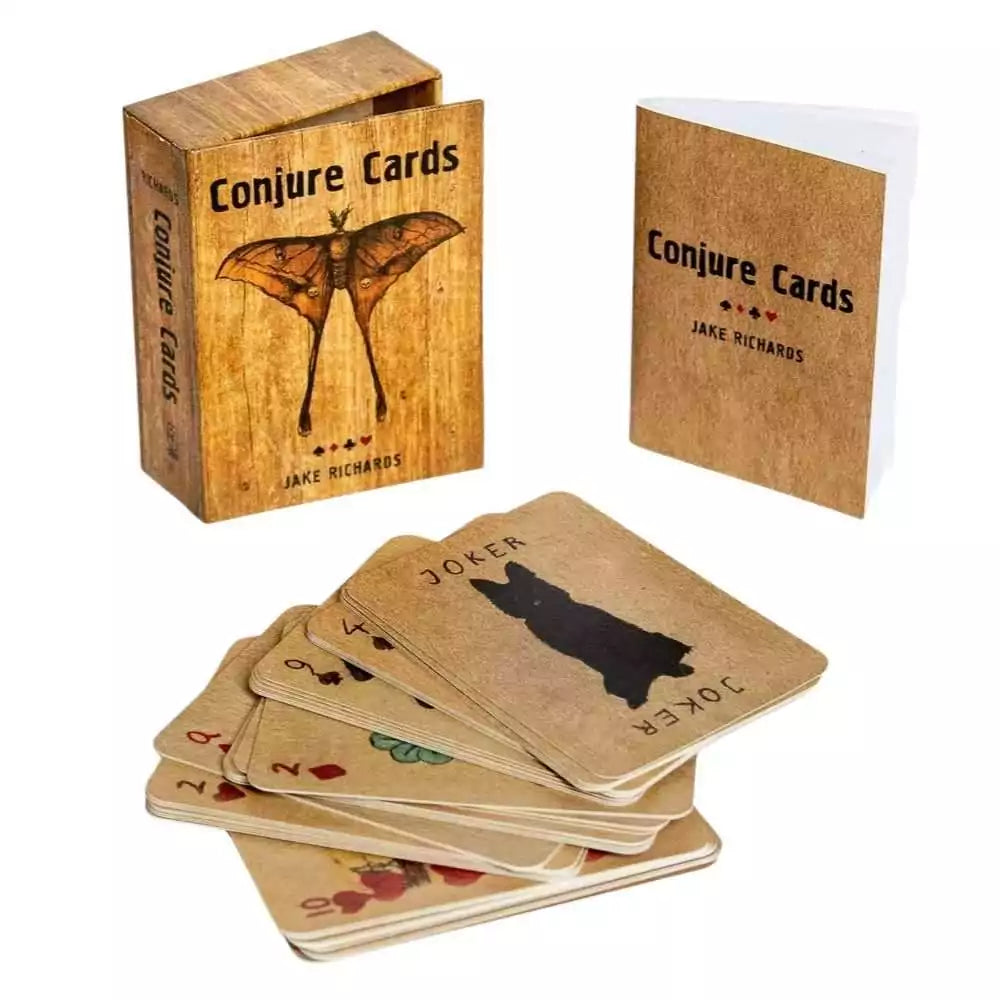 Conjure Cards deck with its wooden box and a guidebook, featuring illustrated cards in an Appalachian folk art style.