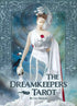 Dreamkeepers Tarot box cover showing a woman in a flowing white gown holding a swan and rose against a deep blue dreamscape background.