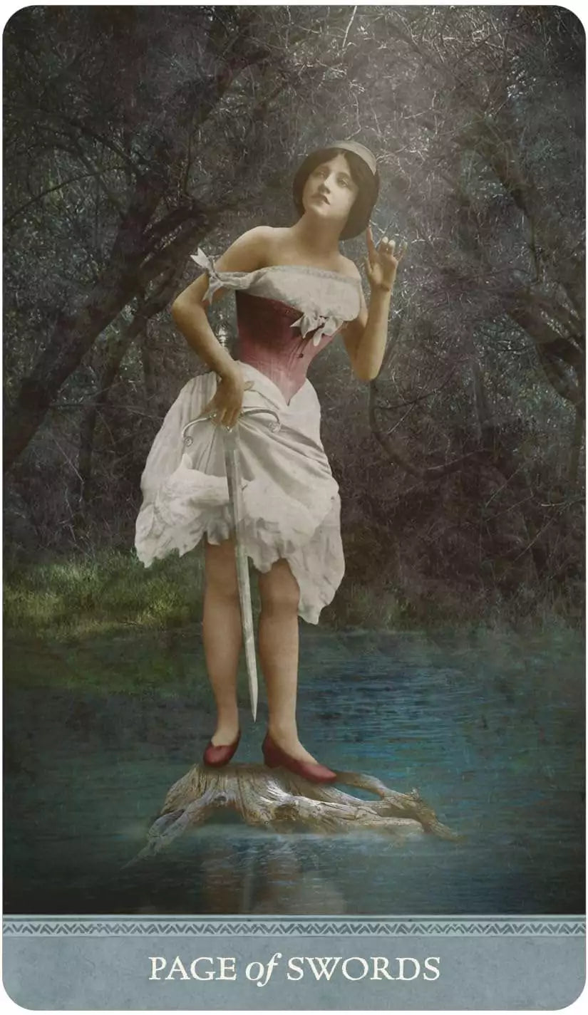 Young woman in vintage dress standing on a rock holding a sword, Dreamkeepers Tarot swords card in misty forest setting.