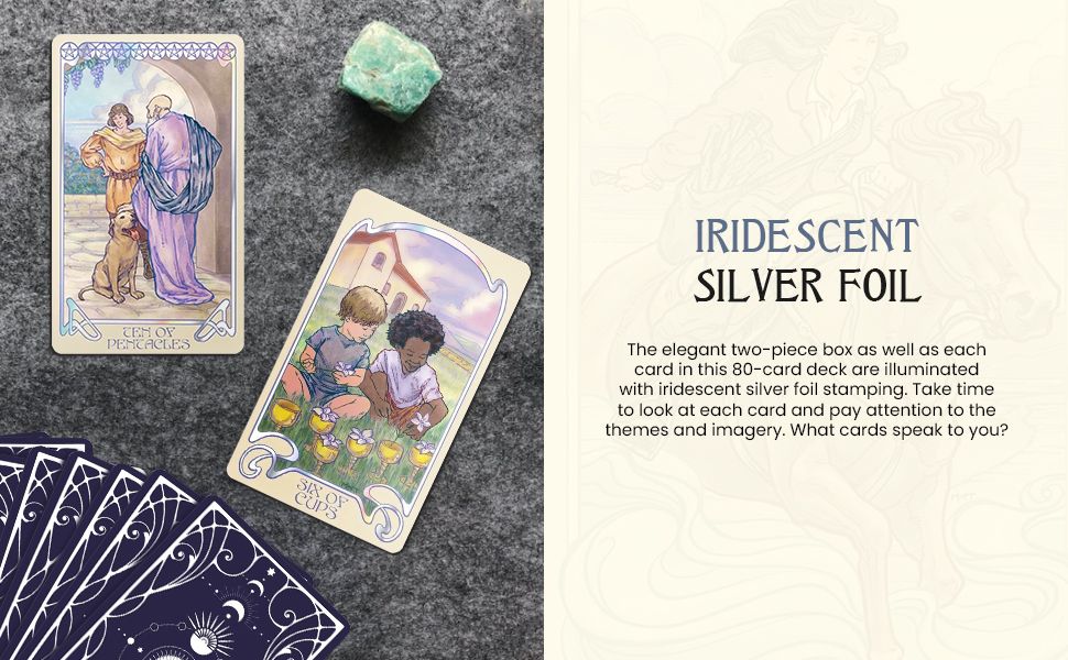 Two Ethereal Visions Tarot cards displayed on a textured surface beside a green crystal and a fanned-out deck.