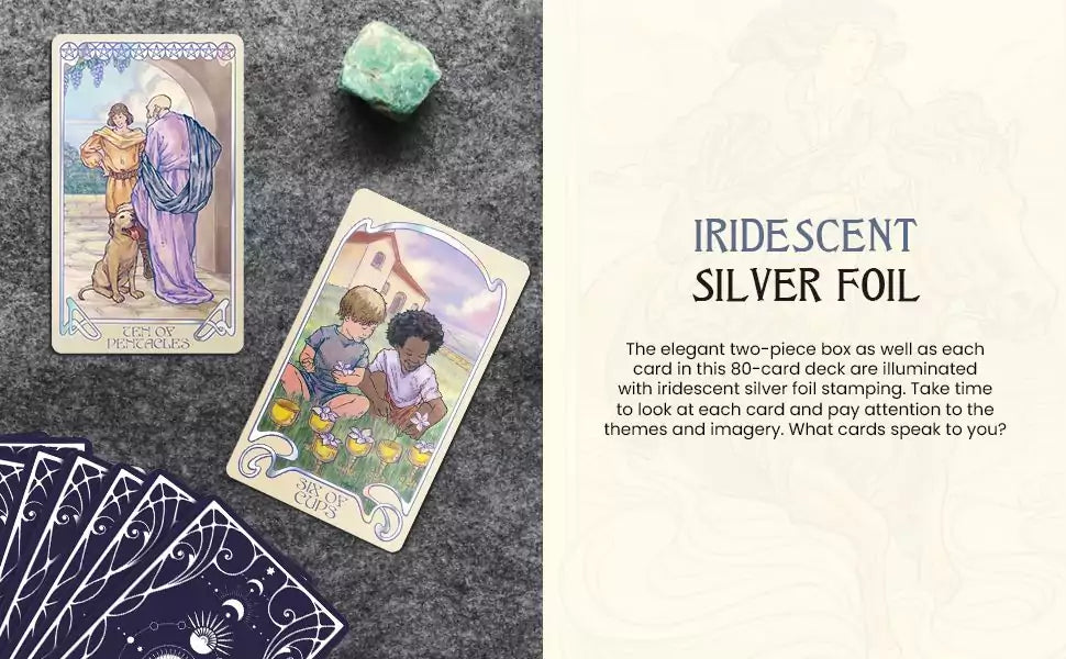 Two Ethereal Visions Tarot cards displayed on a textured surface beside a green crystal and a fanned-out deck.