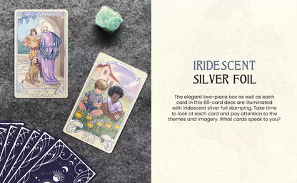 Two Ethereal Visions Tarot cards displayed on a textured surface beside a green crystal and a fanned-out deck.