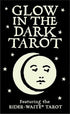 Glow in the Dark Tarot box cover featuring bold white text on black with a stylized moon and face design and scattered stars.
