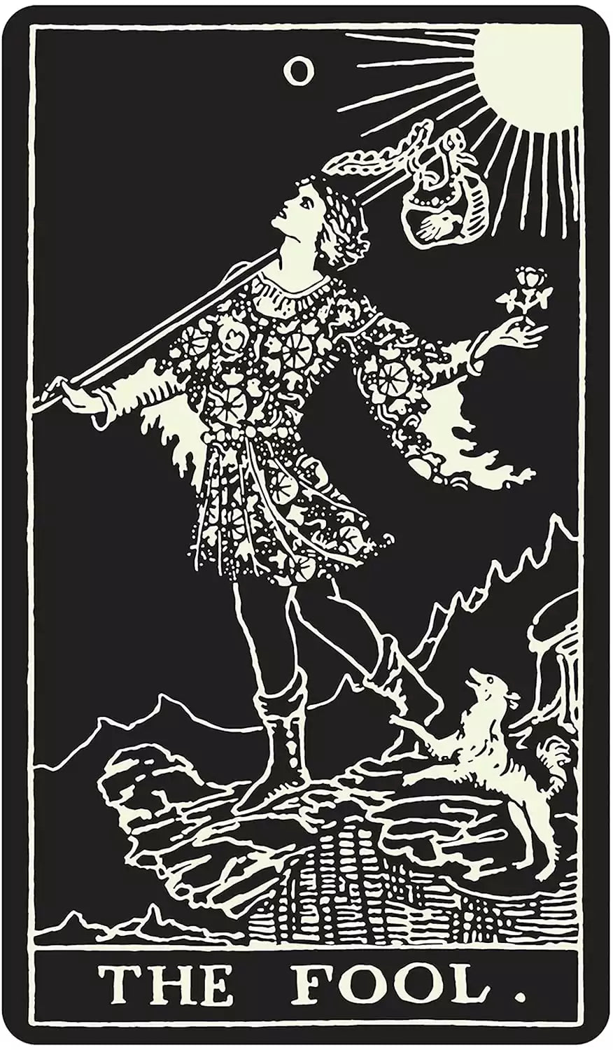 Glow-in-the-dark Tarot card showing The Fool — a figure on a cliff holding a flower, with a dog beside them, in glowing lines on black.