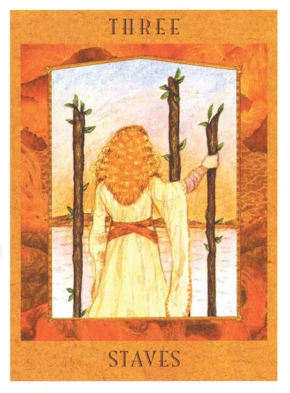 Goddess Tarot card with a woman standing with her back turned, long curly hair cascading down