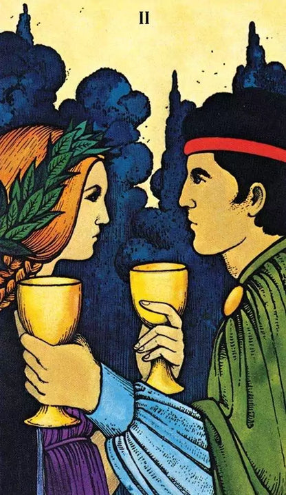Morgan-Greer Tarot card showing a man and woman facing each other holding golden chalices — Two of Cups connection and unity imagery.