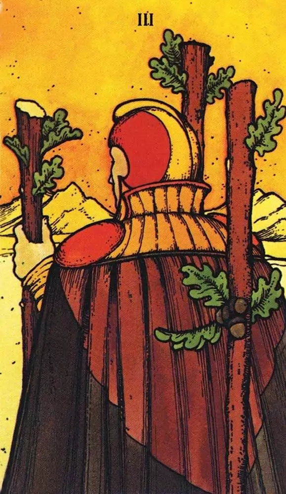 Morgan-Greer Tarot card with cloaked figure standing among three leaf-adorned staffs against warm orange background — contemplative nature scene.