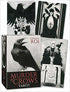 Murder of Crows Tarot box and cards by Corrado Roi featuring dark gothic artwork with crow and mystical figure imagery in black and white.