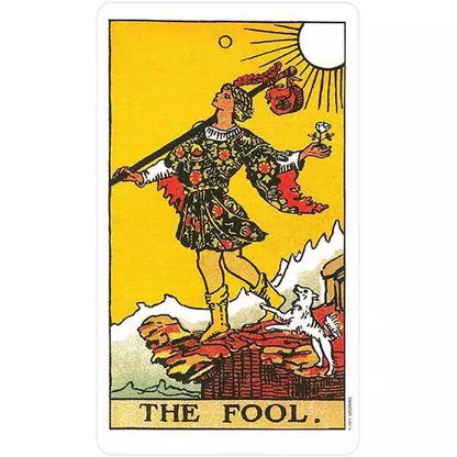 Rider-Waite Tarot Fool card — colorful figure in motley stands on a rocky ledge holding a small bundle, from the Restored Edition deck.