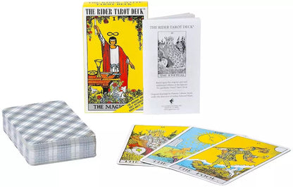 Rider-Waite Tarot deck with guidebook and cards fanned out showing colorful illustrated scenes including the yellow boxed edition.