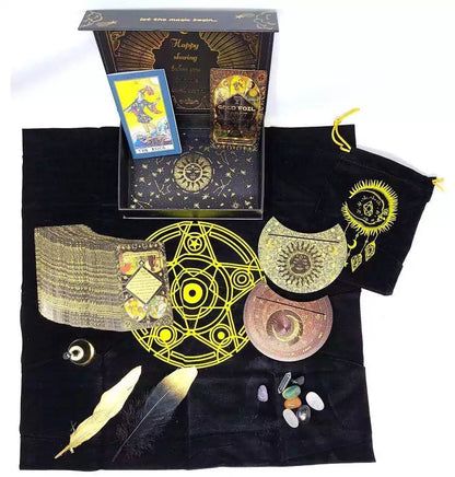 Mystical Rider-Waite gold foil tarot set displayed on black cloth with cards, crystals, and ritual tools with celestial and alchemical symbols.