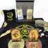 Rider-Waite black and gold foil tarot cards displayed on black cloth with crystals, a feather, and a decorative box showing mystical tarot imagery.