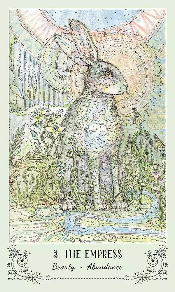 Spiritsong Tarot card featuring a rabbit adorned with intricate patterns surrounded by a lush flowering landscape.